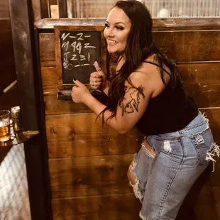 a woman leaning against a wall