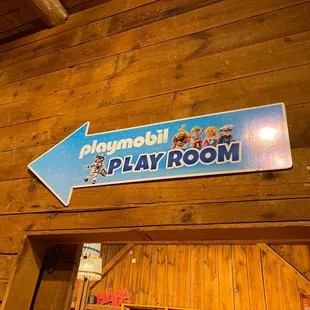a playroom sign above a door