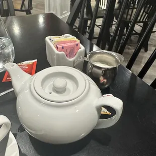 Pot of tea with sugar and cream