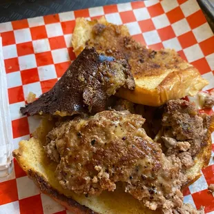 That dark brown thing in the upper left is the burnt cheese. If you zoom in close you'll see some scary looking blue stuff on it.