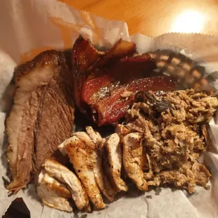 Clockwise from the top, thick cut bacon, pulled pork, chicken, beef brisket.