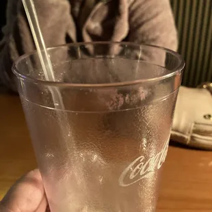 a person holding a glass of water