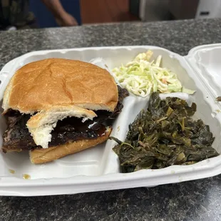 Brisket sandwich with coleslaw and collard greens. To die for!