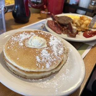 Breakfast sampler with scrambled eggs, hash browns and big fluffy pancakes.
