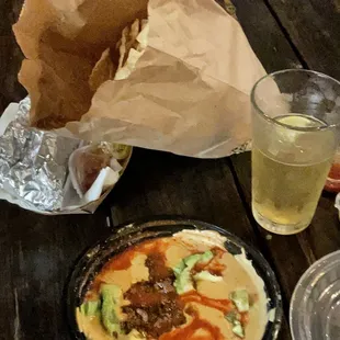 Loaded queso with a large bag of chips