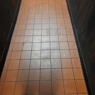 a tiled floor in a public restroom