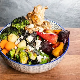 a bowl of vegetables on a cutting board