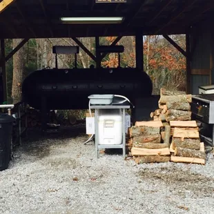 stacked logs in front of a bbq