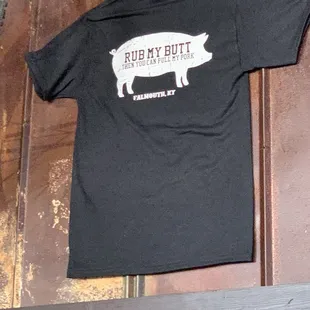 a black t - shirt with a pig on it