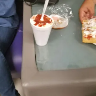 two people eating pizza and a drink