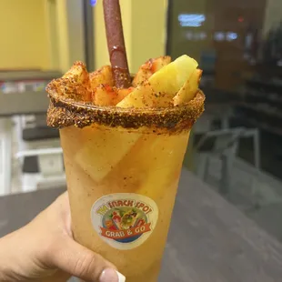 a person holding a cup of food