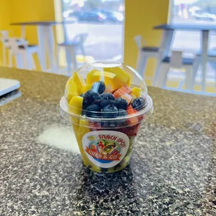 a plastic cup filled with fruit