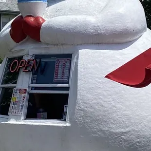 a newspaper stand with a newspaper in the shape of a snowman