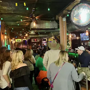 a crowd of people at a bar