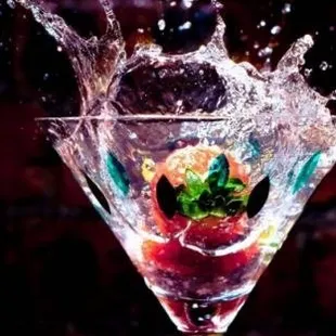 a martini with a strawberry splash