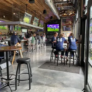 people sitting at tables in a sports bar