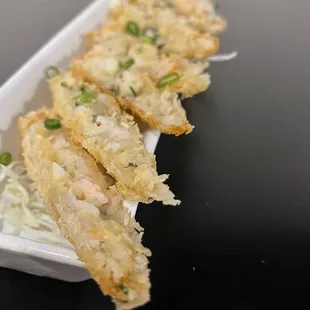 Shrimp Spring Rolls 16 crispy fried bird nest rice paper wrapped shrimp rolls, chili pepper water Thai vinaigrette