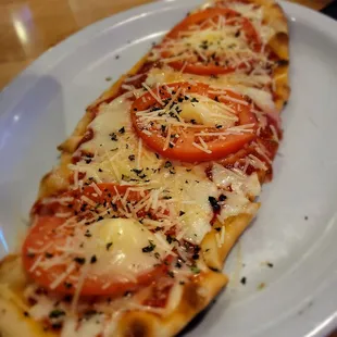 a pizza with tomatoes and cheese