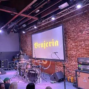 a group of people sitting in front of a projector screen