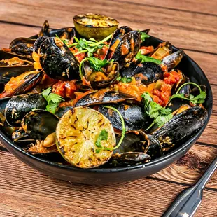 a bowl of mussels and other foods