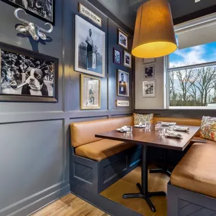 a corner booth with a table and chairs
