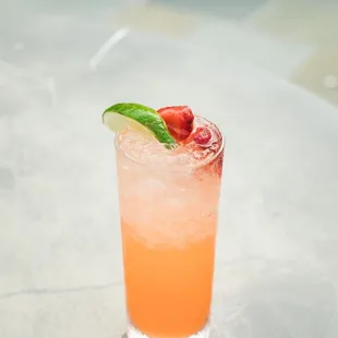a cocktail with a strawberry garnish