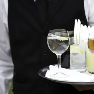 a waiter carrying a tray of drinks