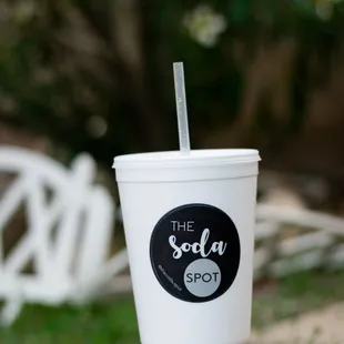 a white cup with a straw