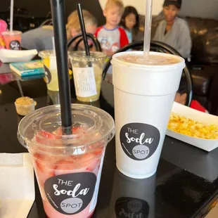 two cups of soda and a plate of food