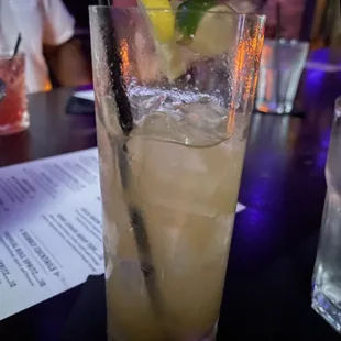 a glass of lemonade and a lemon wedge
