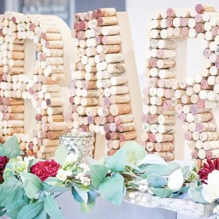 a table with wine corks and flowers