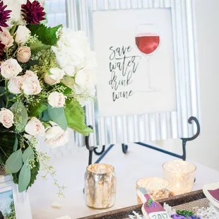 a table with wine glasses and flowers