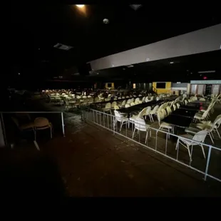 rows of chairs in a darkened room