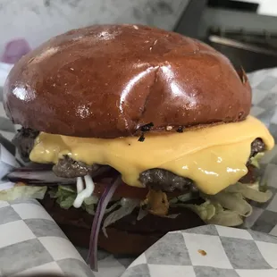 a hamburger with cheese and lettuce