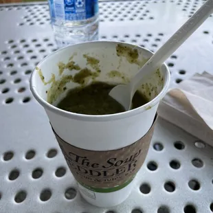 a cup of soup with a spoon