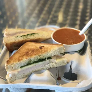 TURKEY, CILANTRO PESTO, SPINACH, PEPPER JACK Sandwich and tomato basil soup.