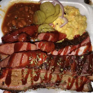Da Greedy our slow smoked meats (Brisket, sausage, ribs and chicken) house potatoe salad and baked beans &amp; green's, bread and pickles, onion