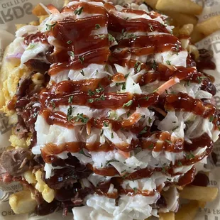 Our house loaded TRASH CAN FRIES, loaded with smoked brisket and more with house hot henny sauce.