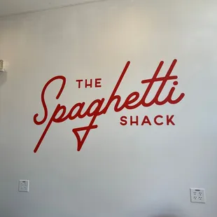 a red chair in front of the sign