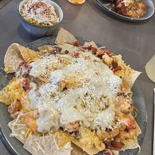 Shrimp nachos, roadside corn, dos plate
