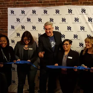 Governor Eric Holcomb cutting the tape on opening of Kenzie Academy