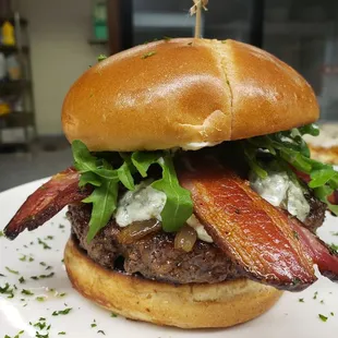 a burger with bacon and lettuce