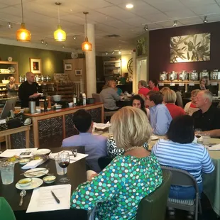 a large group of people sitting at tables in a restaurant