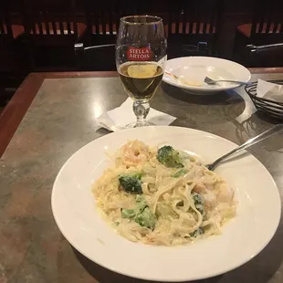 Seafood Alfredo with broccoli and a cold Stella