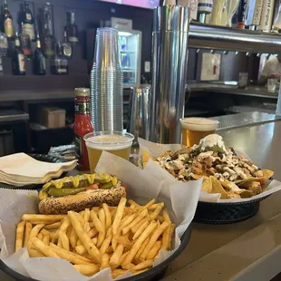 Chicago style hotdog on the left and chicken nachos on the right.