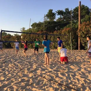 a group of people playing volleyball