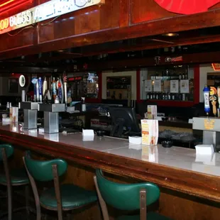 a bar with green chairs