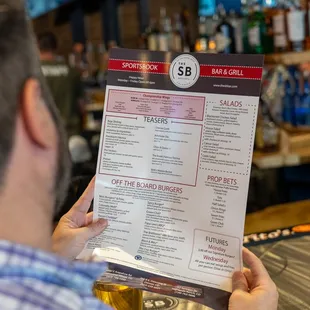  a man holding a menu