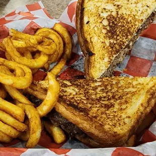 a basket of fries and a grilled cheese sandwich