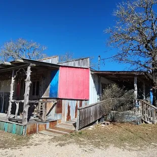 an old house with a red and blue door